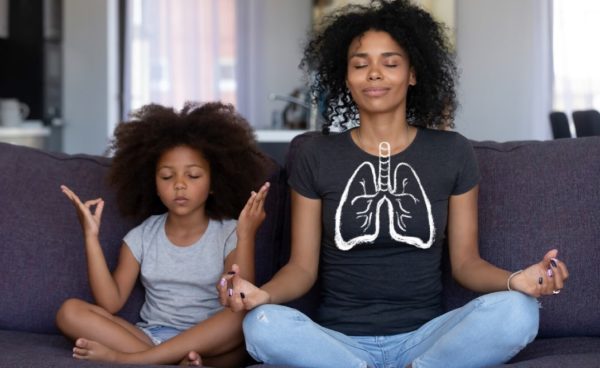 diverse mother and daughter breathing in with healthy lungs