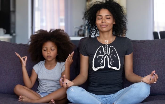 diverse mother and daughter breathing in with healthy lungs